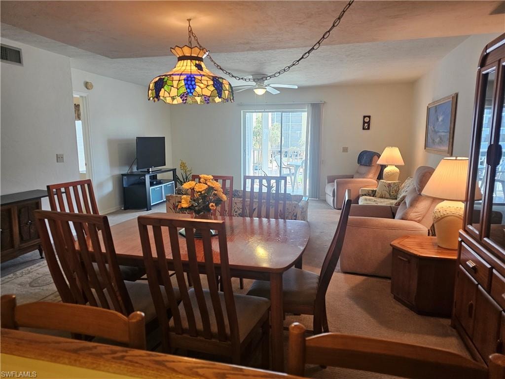 Dining room with a ceiling fan and a textured ceiling