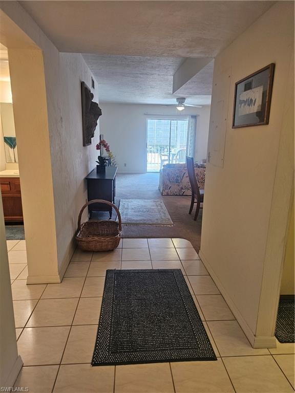 Corridor with light tile patterned floors