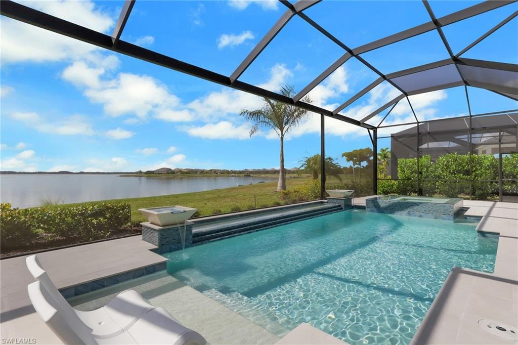 View of pool featuring a lanai, a water view, a sunroom, a pool with connected hot tub, and a patio