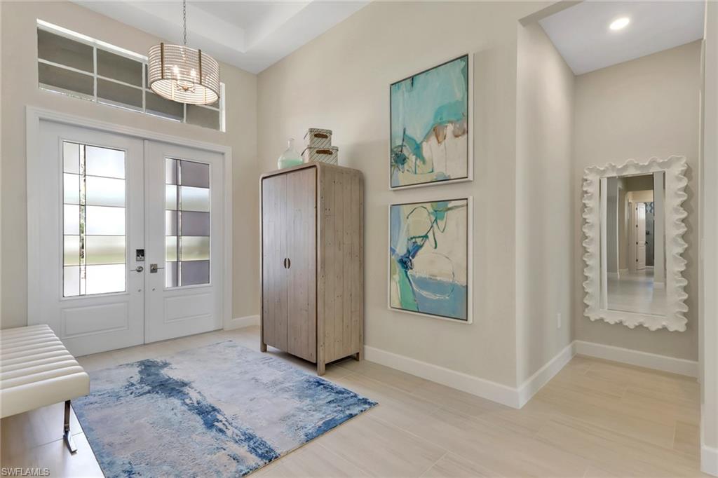 Foyer with french doors and a high ceiling