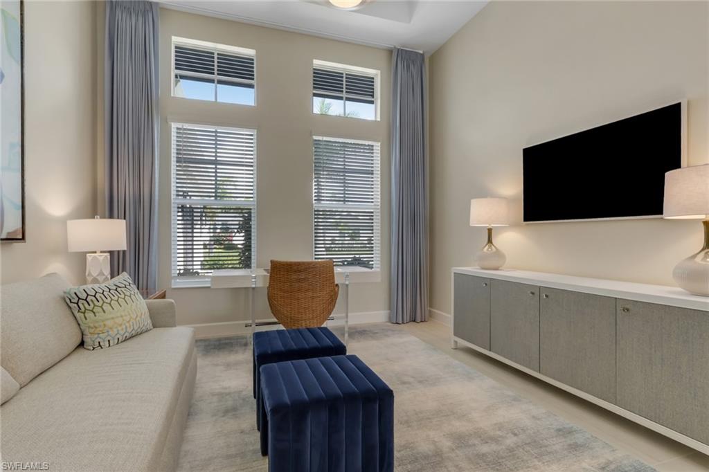 Living area with healthy amount of natural light and a high ceiling