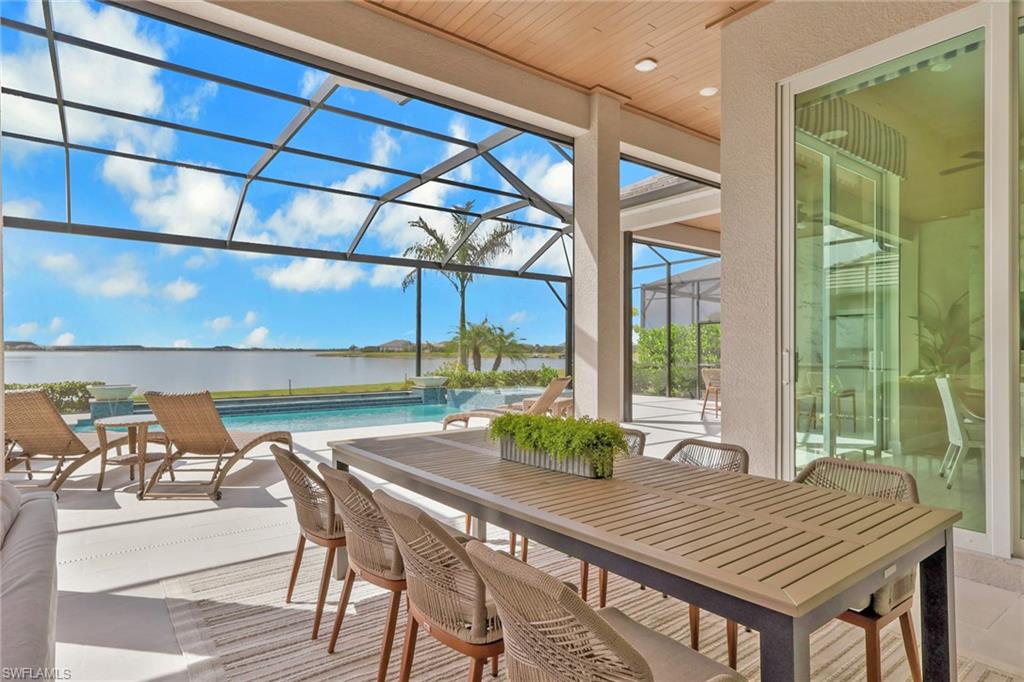Sunroom featuring a patio area, ceiling fan, and outdoor dining area