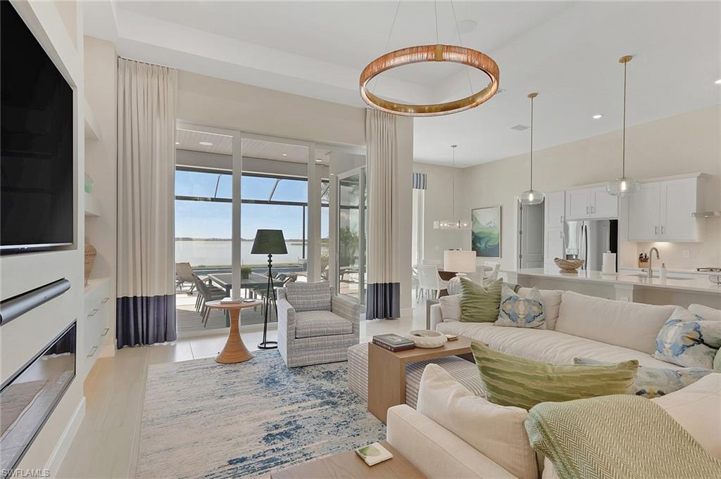 Living room featuring recessed lighting, a water view, and a fireplace