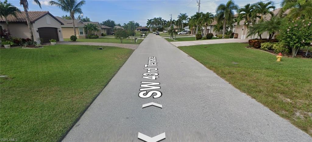 View of asphalt road featuring a residential view