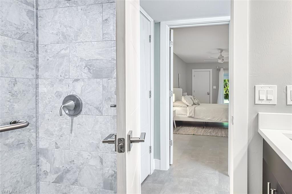 Bathroom featuring vanity, a walk-in shower, a ceiling and ensuite bath