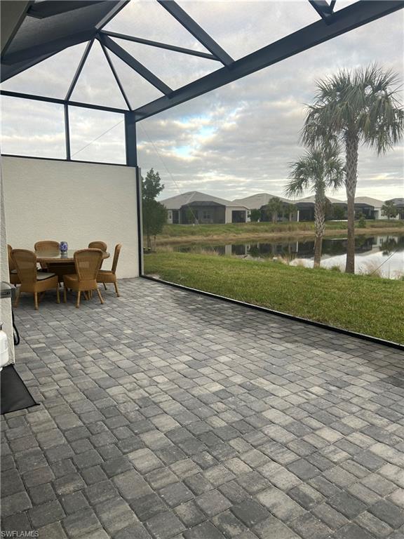 Sunroom featuring a water view