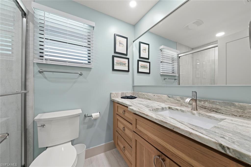Full bathroom featuring a shower stall, vanity, and recessed lighting