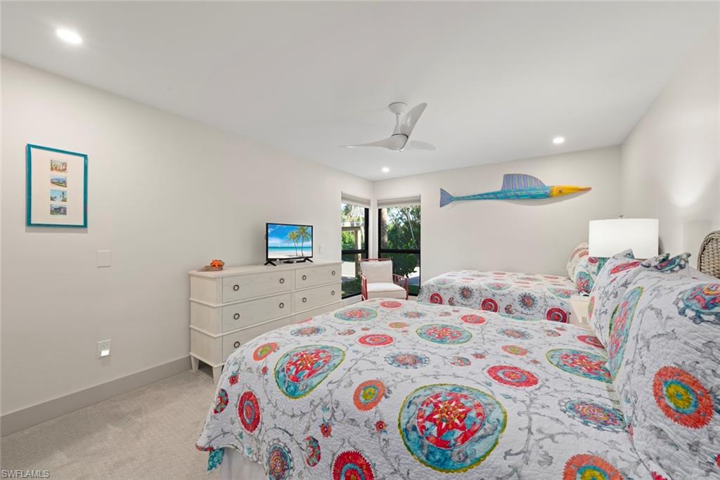 Bedroom with ceiling fan, light colored carpet, and recessed lighting