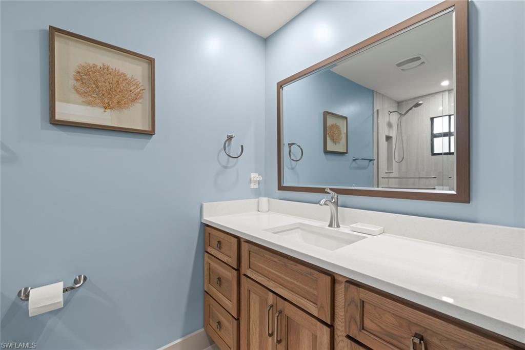 Bathroom with vanity and a shower