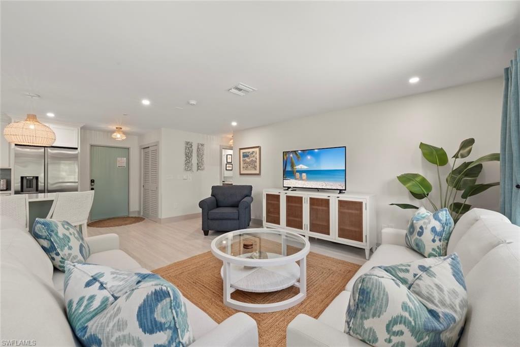 Living room featuring light wood-type flooring and recessed lighting