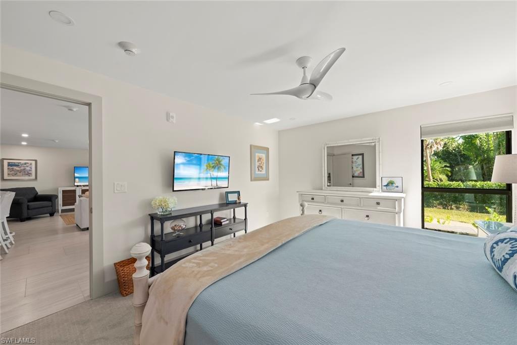 Carpeted bedroom with ceiling fan and recessed lighting