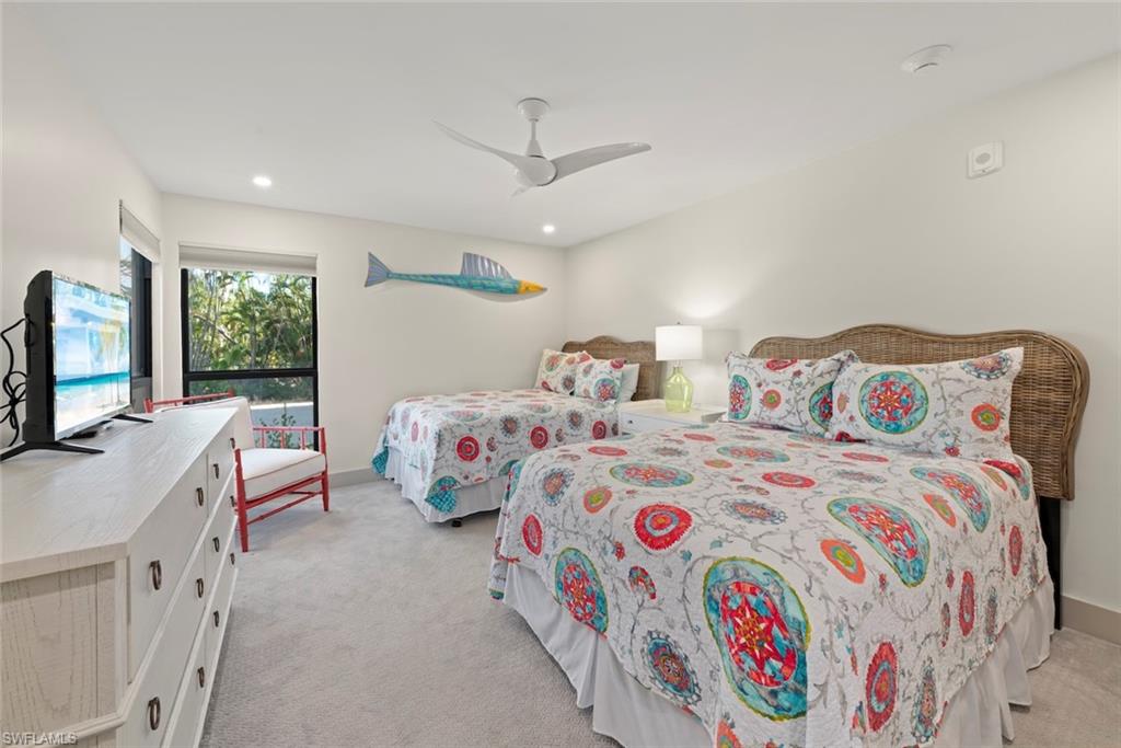 Bedroom featuring light carpet, a ceiling fan, and recessed lighting