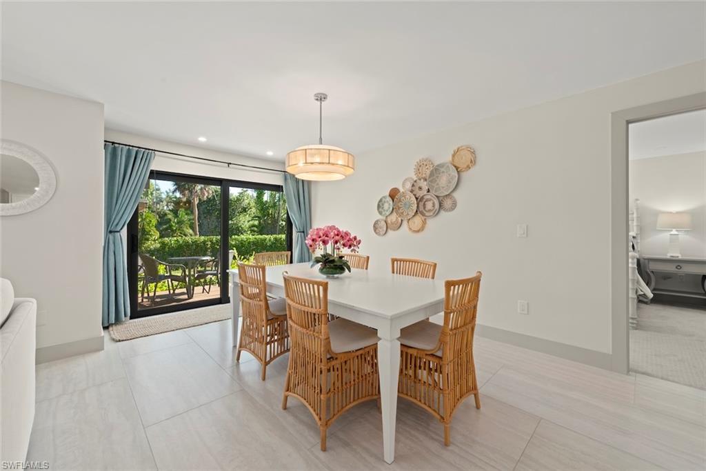 Dining area featuring light tile patterned floors and recessed lighting