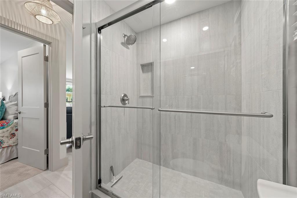 Full bathroom featuring a shower stall and connected bathroom