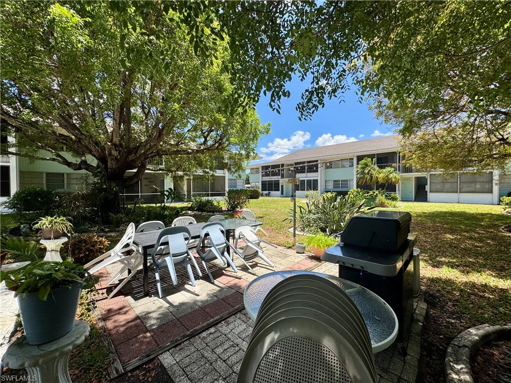 View of home's community with a yard and shuffleboard