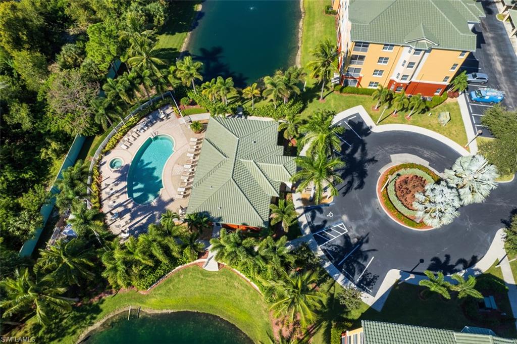 Bird's eye view of a nearby body of water and a pool area