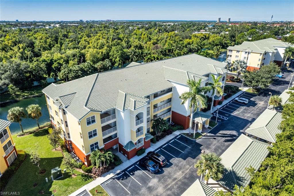 Drone / aerial view of a large body of water and apartment complex / building