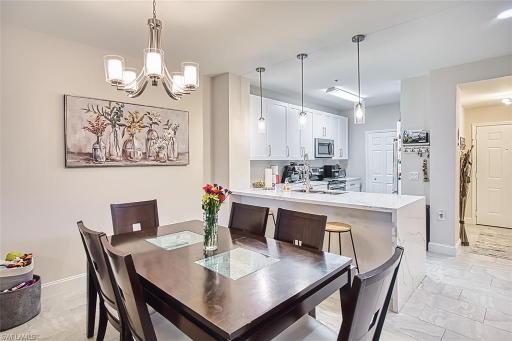 Dining room featuring a chandelier and baseboards