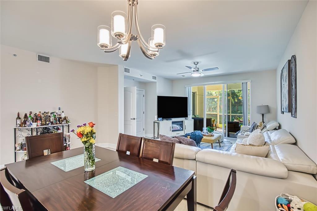 Dining room with a chandelier and ceiling fan
