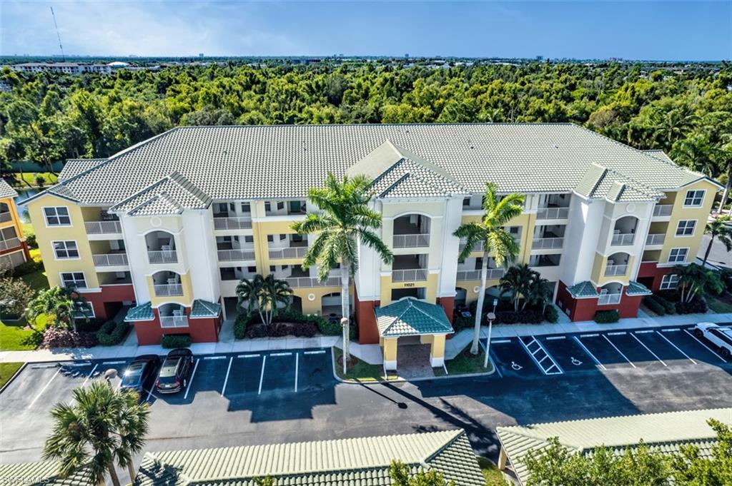 View of apartment building / complex with uncovered parking