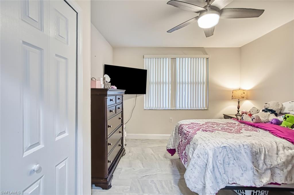 Bedroom featuring ceiling fan and baseboards