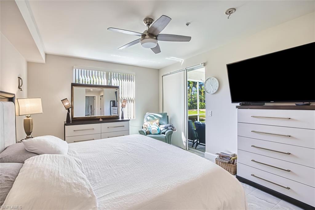Bedroom with access to exterior, ceiling fan, and light tile patterned flooring