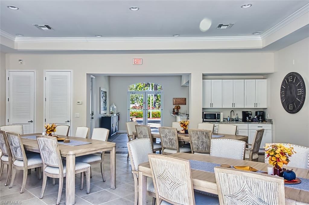 Dining space featuring ornamental molding, light tile patterned floors, recessed lighting, french doors, and a tray ceiling