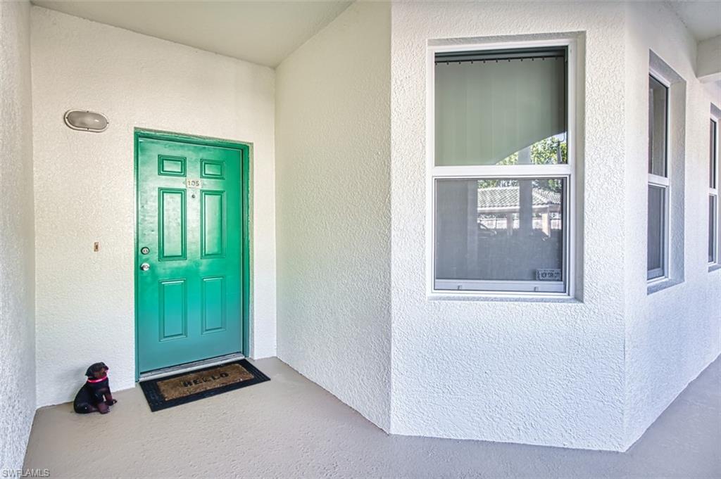 Property entrance featuring stucco siding