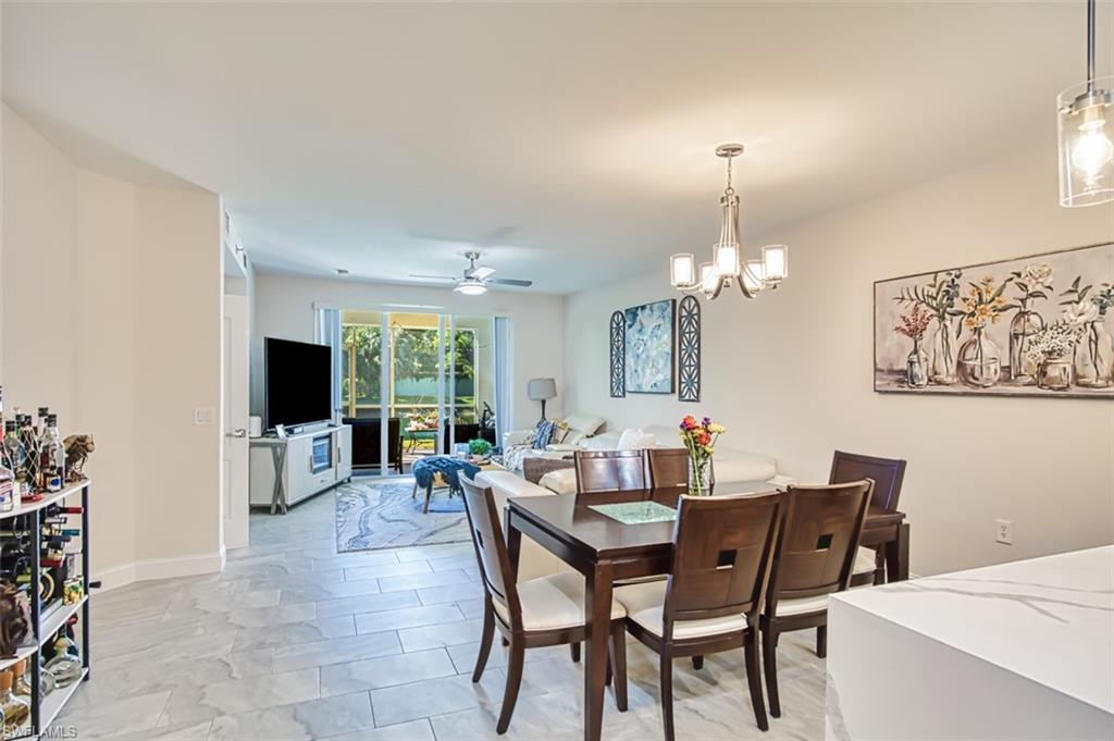 Dining area featuring a ceiling fan and a chandelier