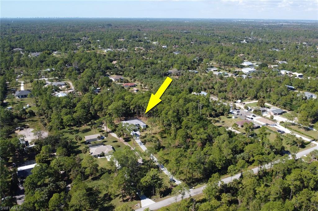 View of property location with a heavily wooded area