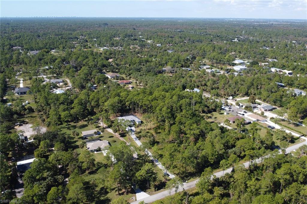 Aerial view of property's location with a forest
