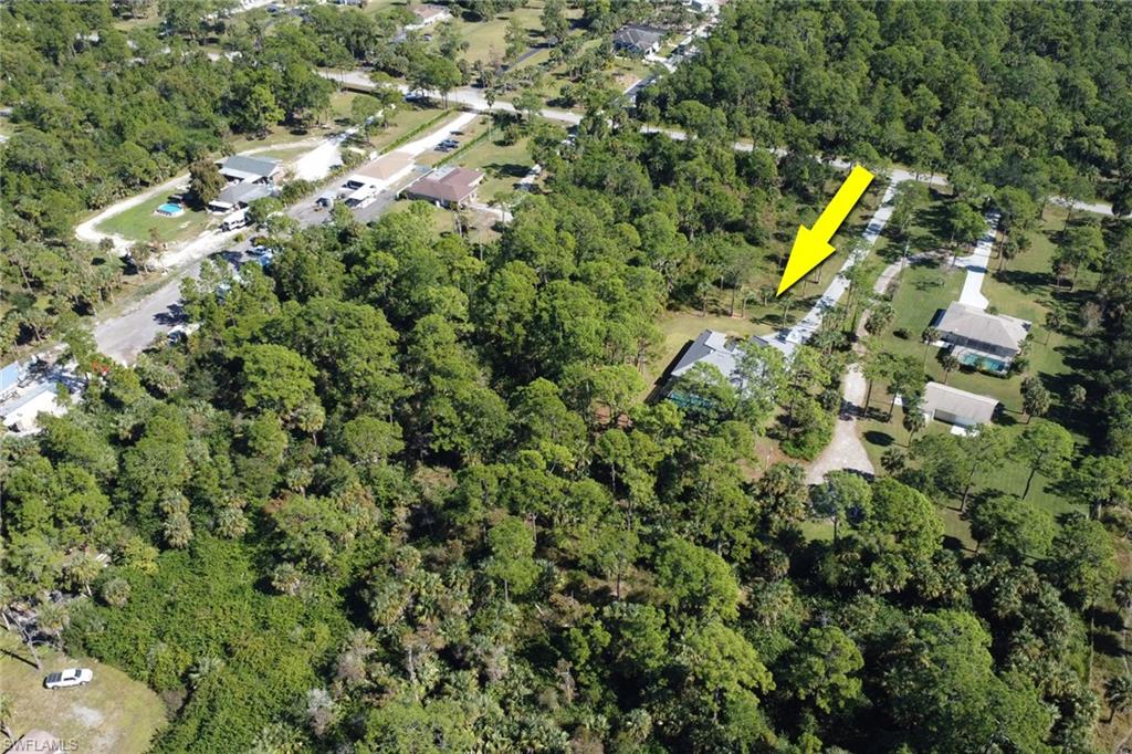 Aerial view of property's location featuring a forest