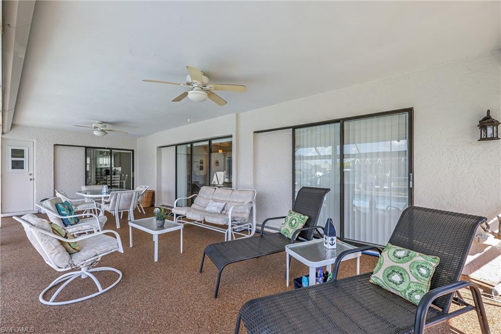 View of patio with ceiling fan, outdoor lounge area, and outdoor dining area