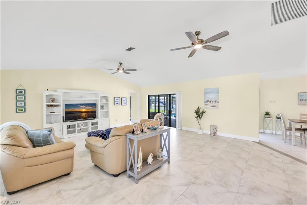 Living area featuring lofted ceiling and a ceiling fan