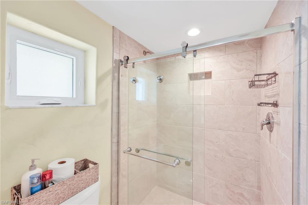 Bathroom featuring a stall shower and toilet