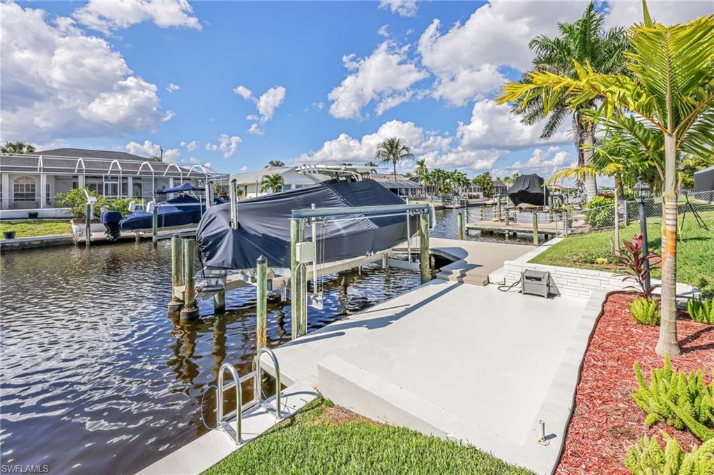 Dock area with a water view and boat lift