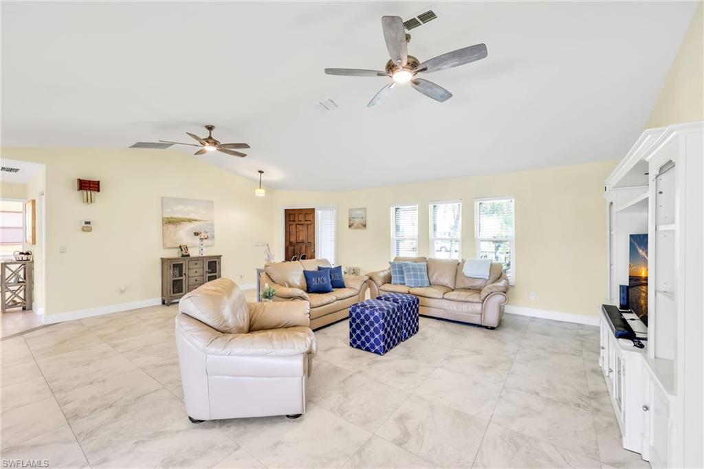 Living area with lofted ceiling and a ceiling fan