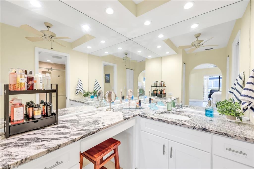 Bathroom with a ceiling fan, vanity, recessed lighting, and ensuite bathroom