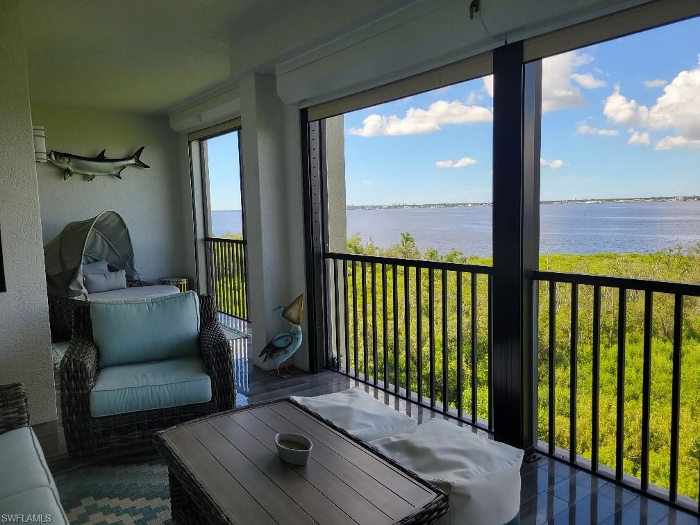 Sunroom featuring a water view