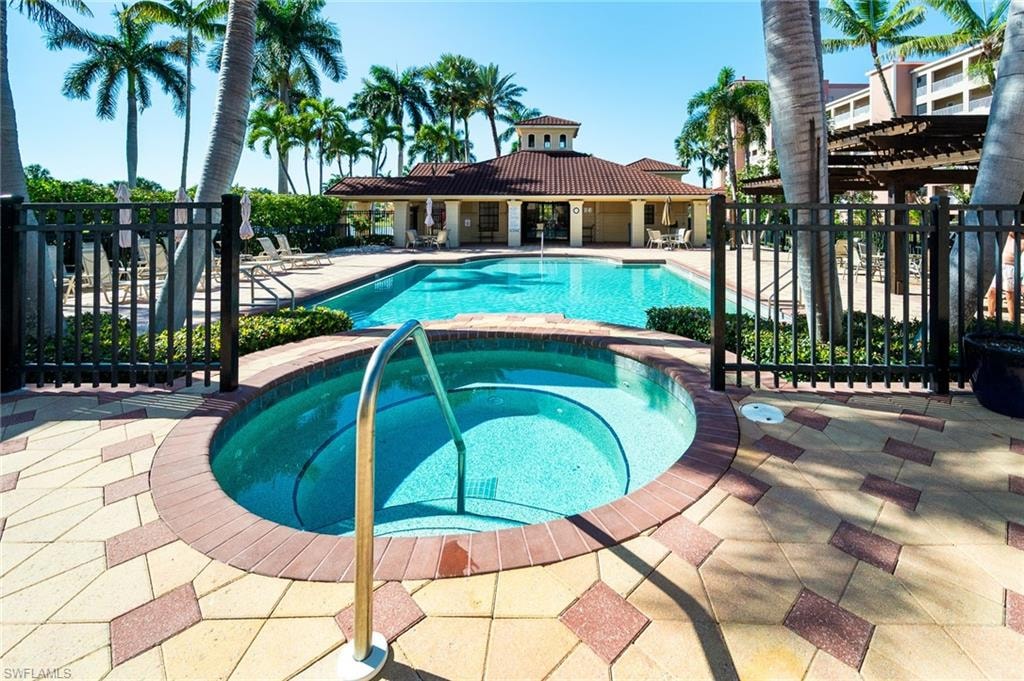 Community pool with a patio, a community hot tub, and a pergola