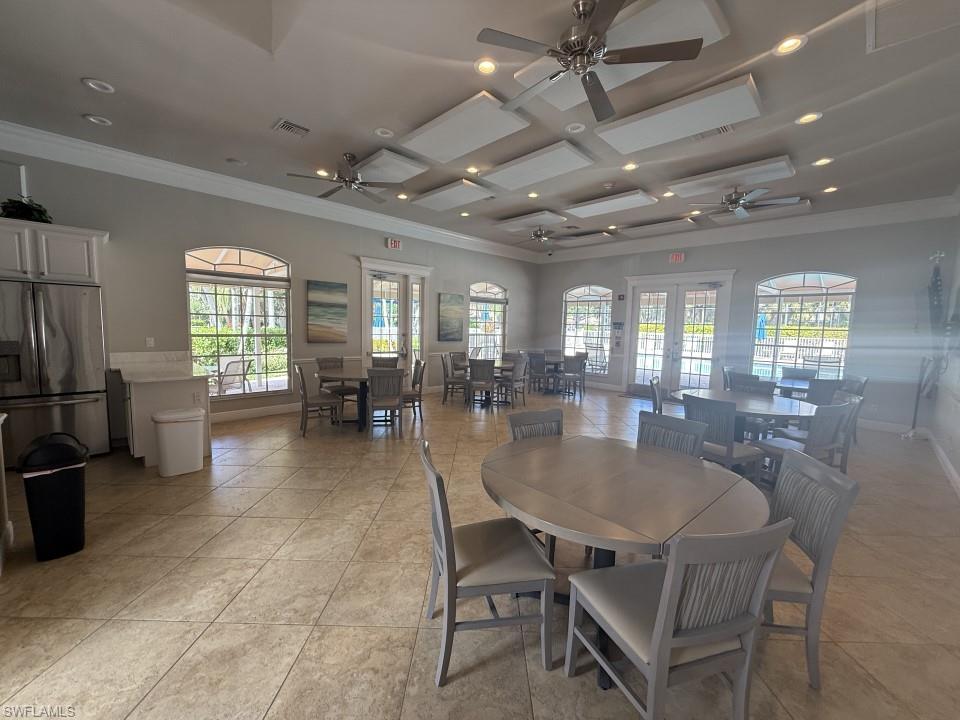 Clubhouse Dining room with recessed lighting, plenty of natural light, coffered ceiling, a ceiling fan, and crown molding