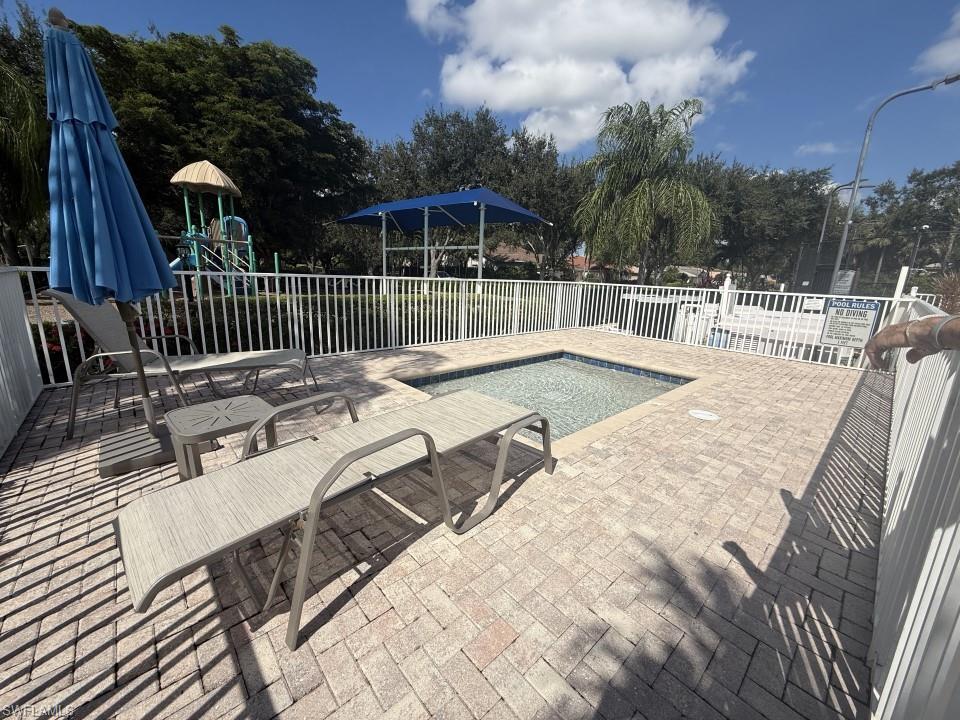 Community Outdoor pool with a patio area