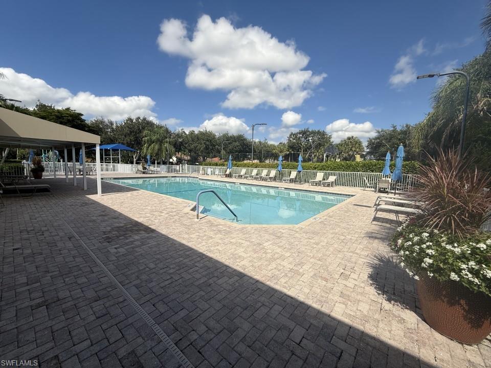 Community pool with a patio