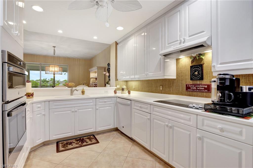 Kitchen featuring white cabinetry, recessed lighting, stainless steel double oven, light tile patterned floors, and dishwasher