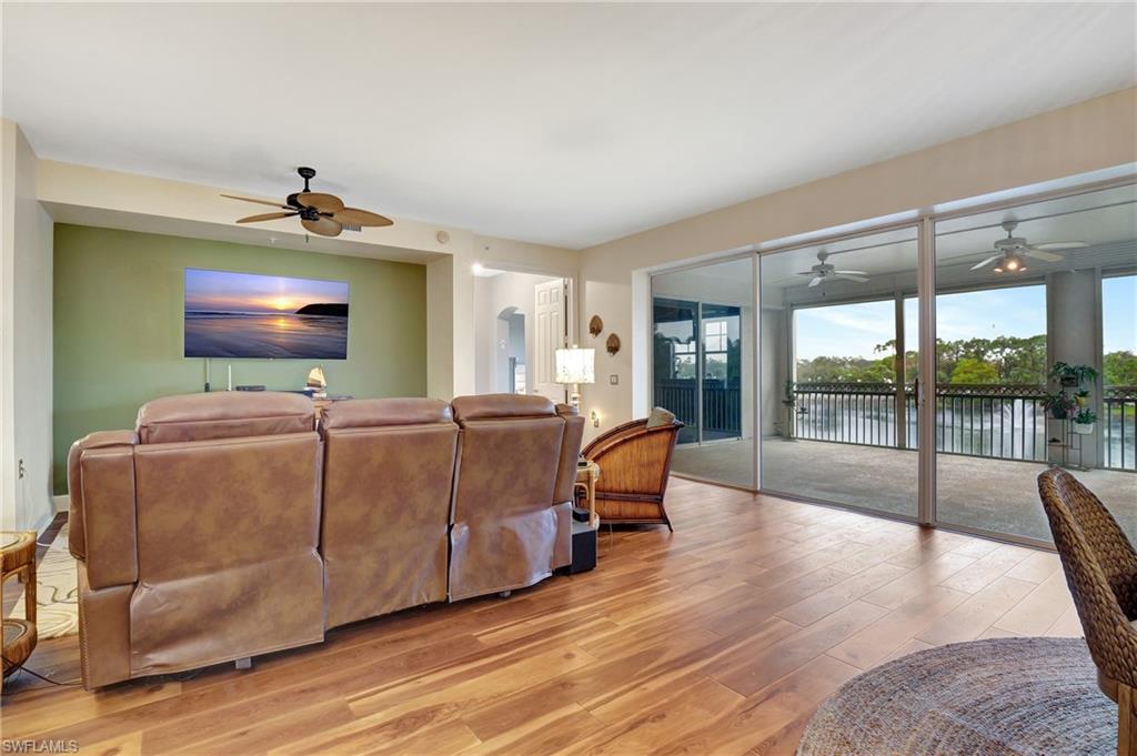 Living room with light wood-style flooring and ceiling fan