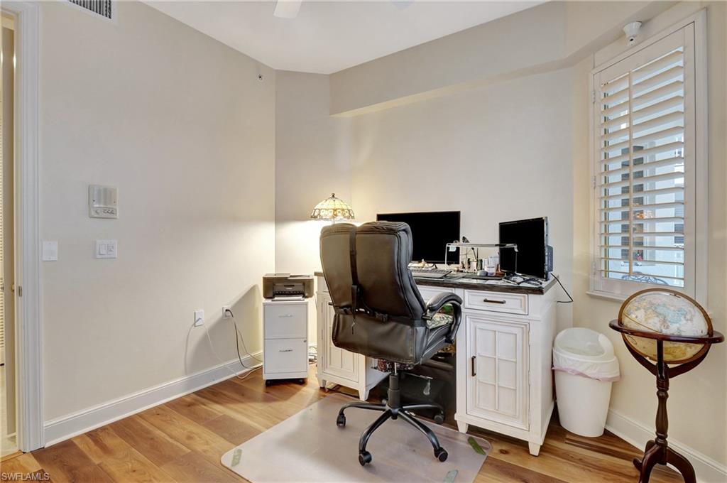 Office area featuring light wood-style floors and ceiling fan