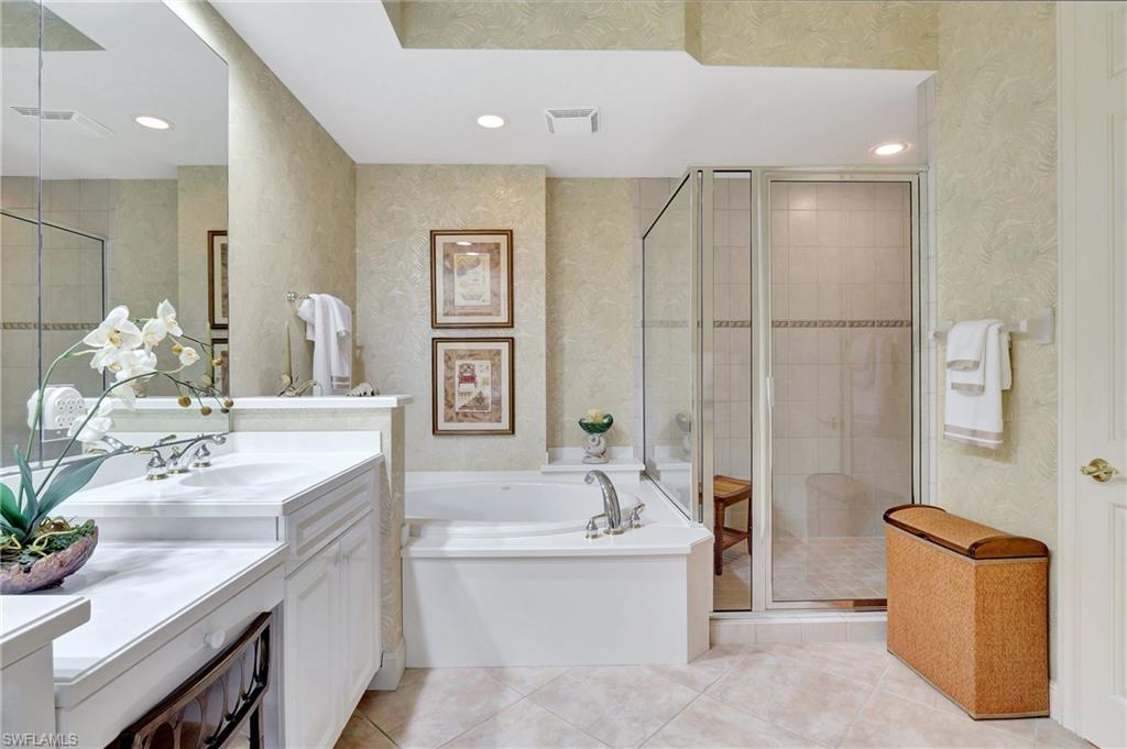 Full bathroom with a bath, vanity, light tile patterned floors, a shower stall, and recessed lighting