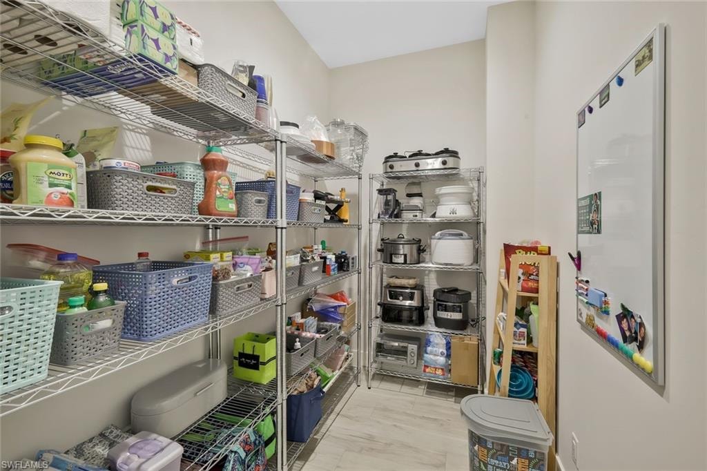 Large pantry tucked away behind kitchen with easy access to garage.