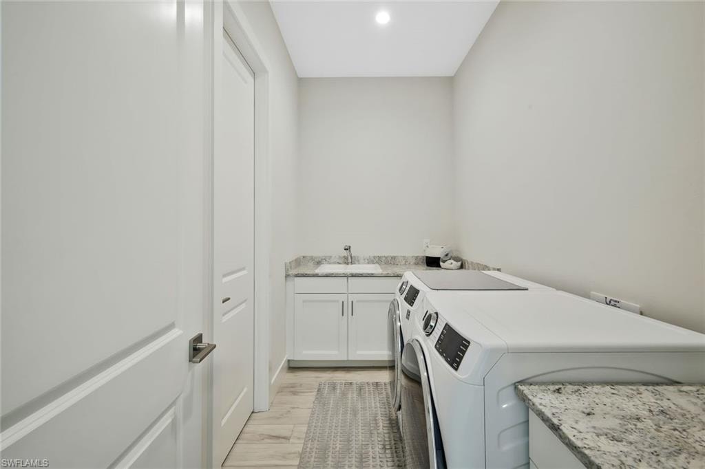 Laundry Room with front load smart washer and dryer.