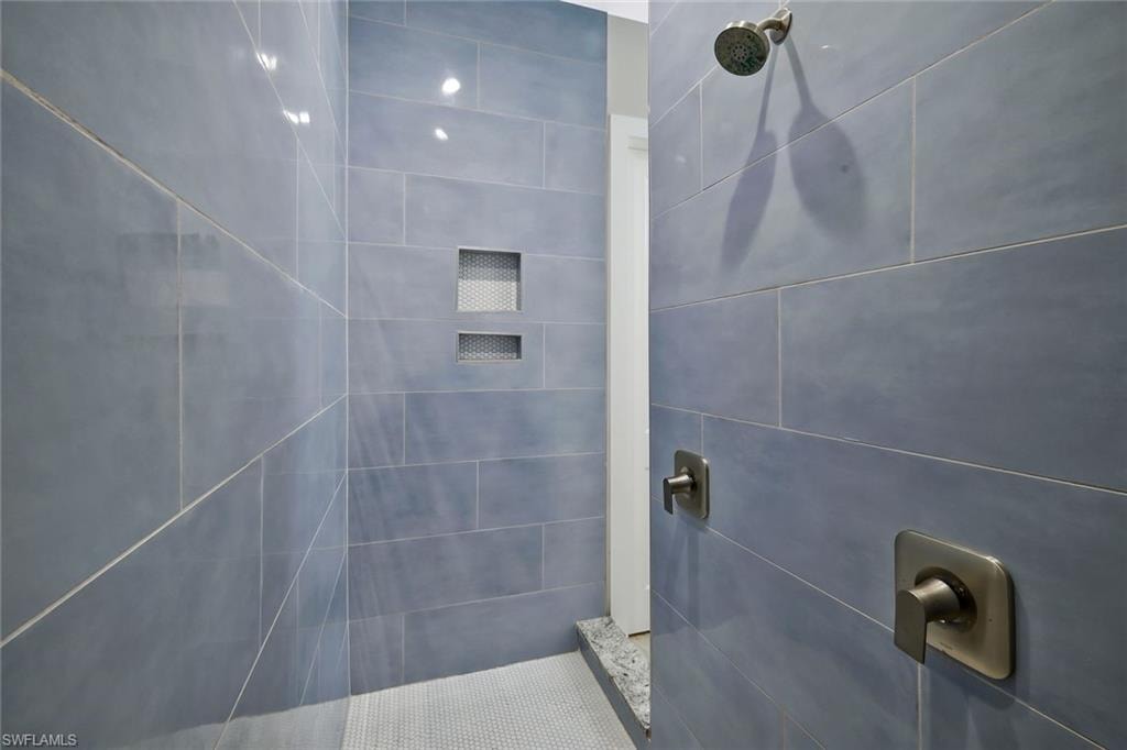 Custom walk-through shower with duel showerheads.